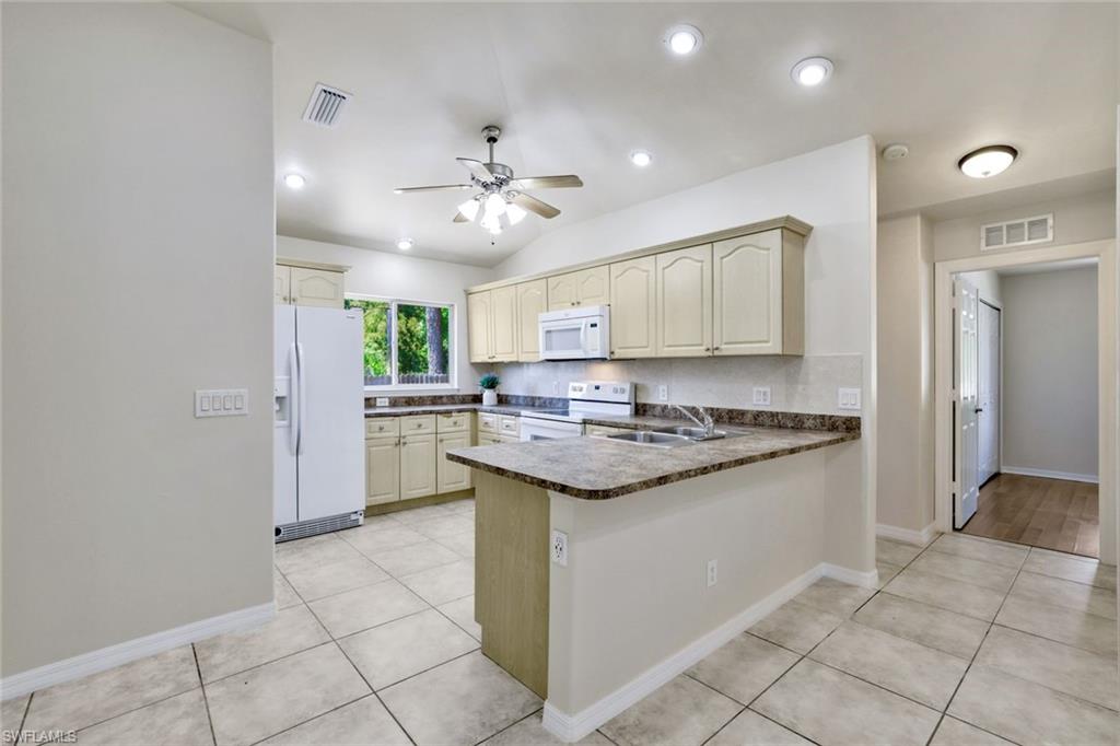 18355 Fuchsia Road Fort Myers, FL 33967 - Photo 8 of 13 a kitchen with granite countertop a sink and a stove