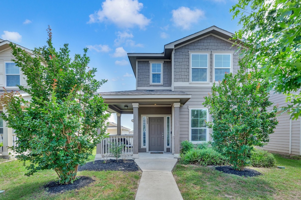 a front view of a house with garden
