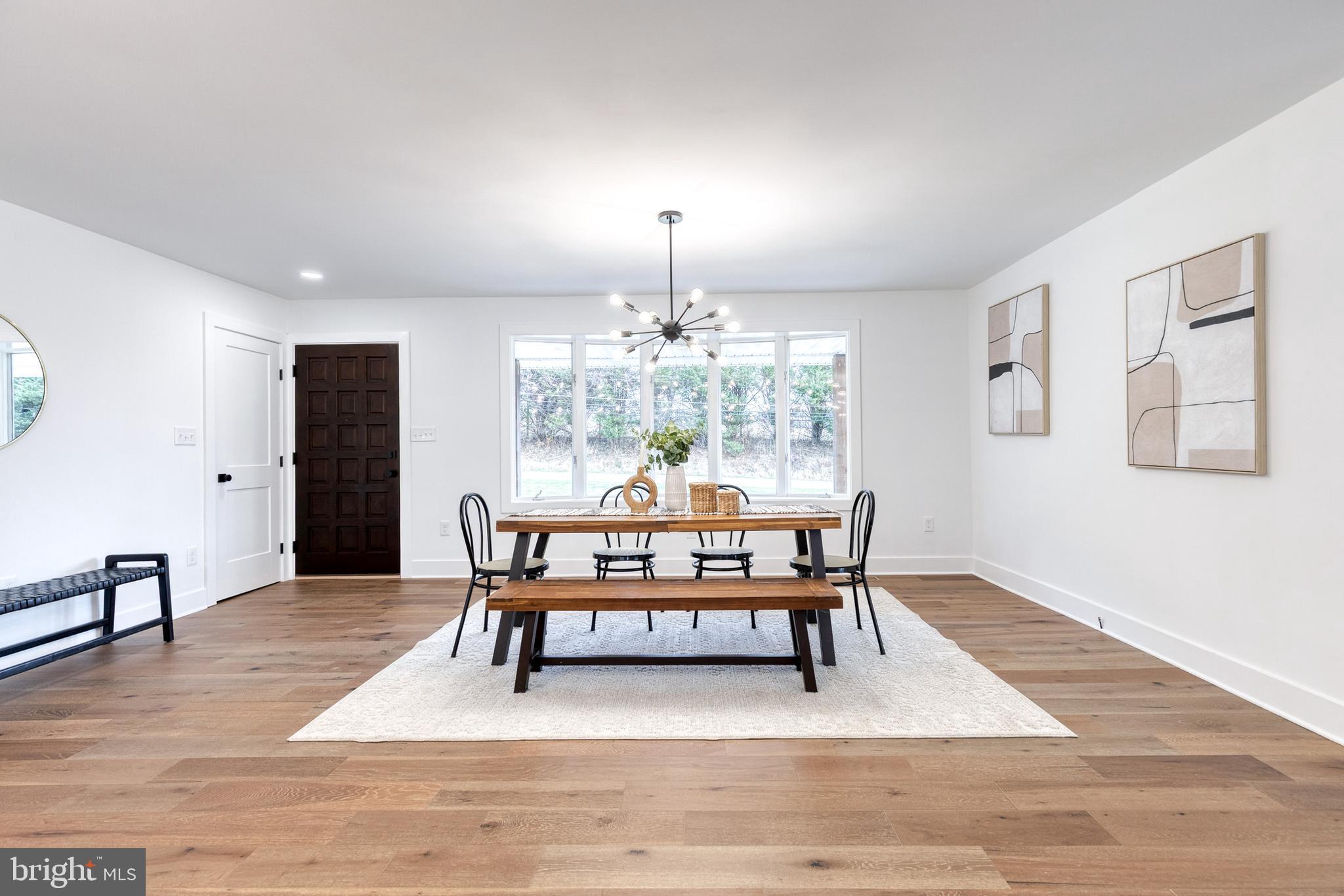 4011 Perry Hall Road Perry Hall, MD 21128 - Photo 16 of 51 a dining room with furniture a chandelier and wooden floor