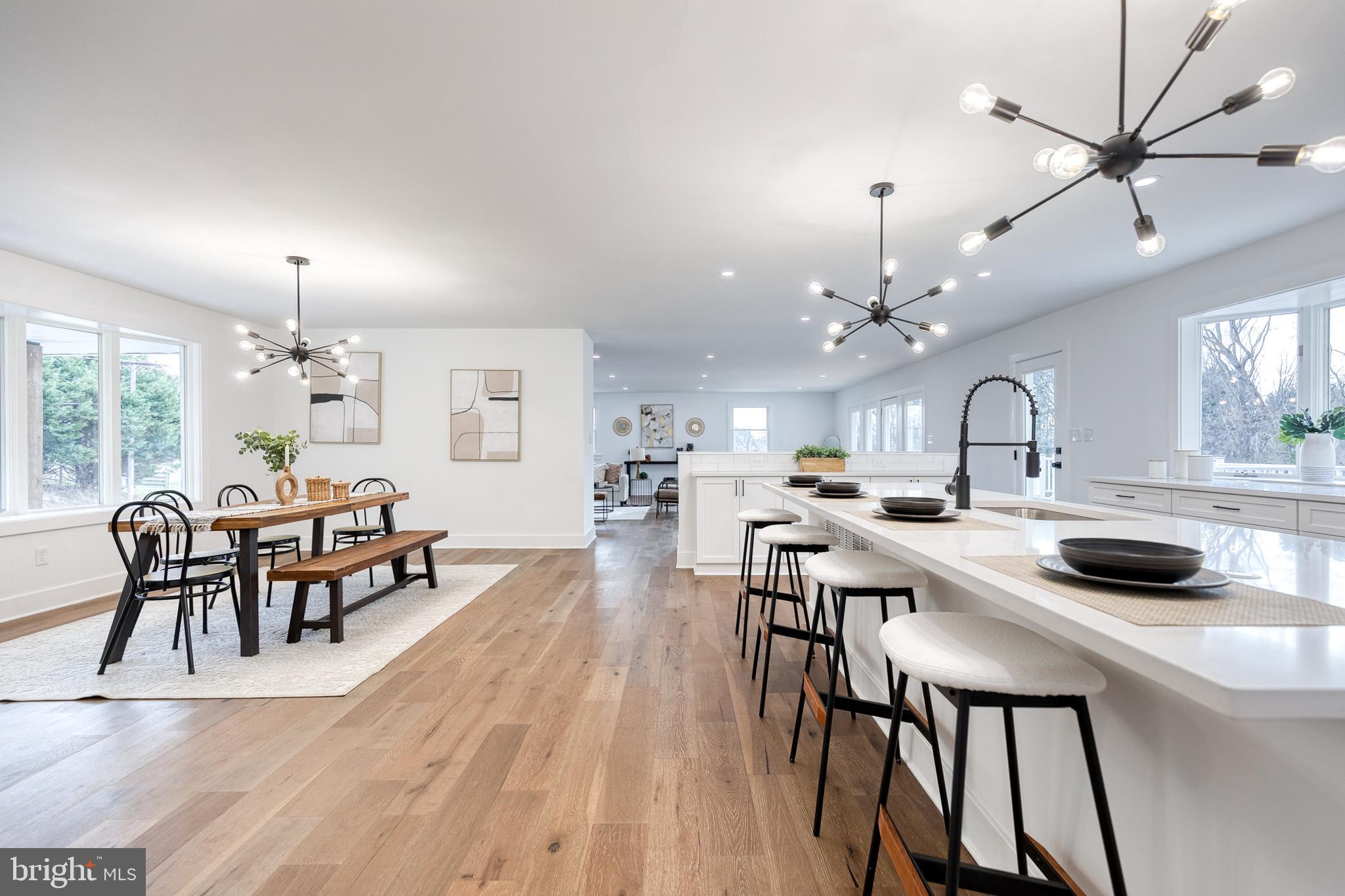 4011 Perry Hall Road Perry Hall, MD 21128 - Photo 19 of 51 a kitchen with kitchen island a dining table and chairs with wooden floor