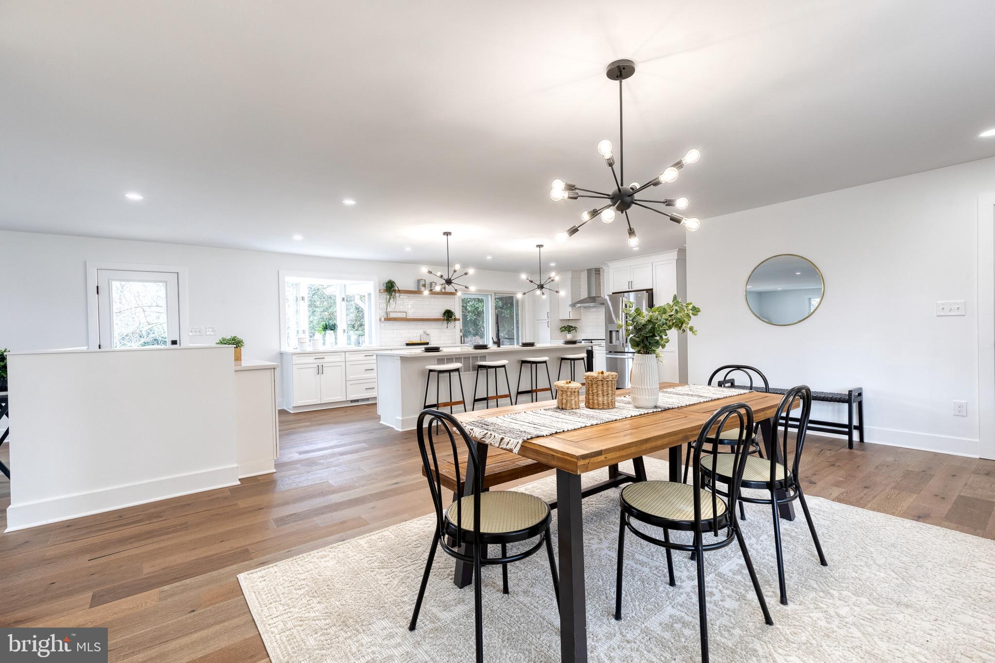 4011 Perry Hall Road Perry Hall, MD 21128 - Photo 22 of 51 a view of a dining room and livingroom with furniture wooden floor a chandelier