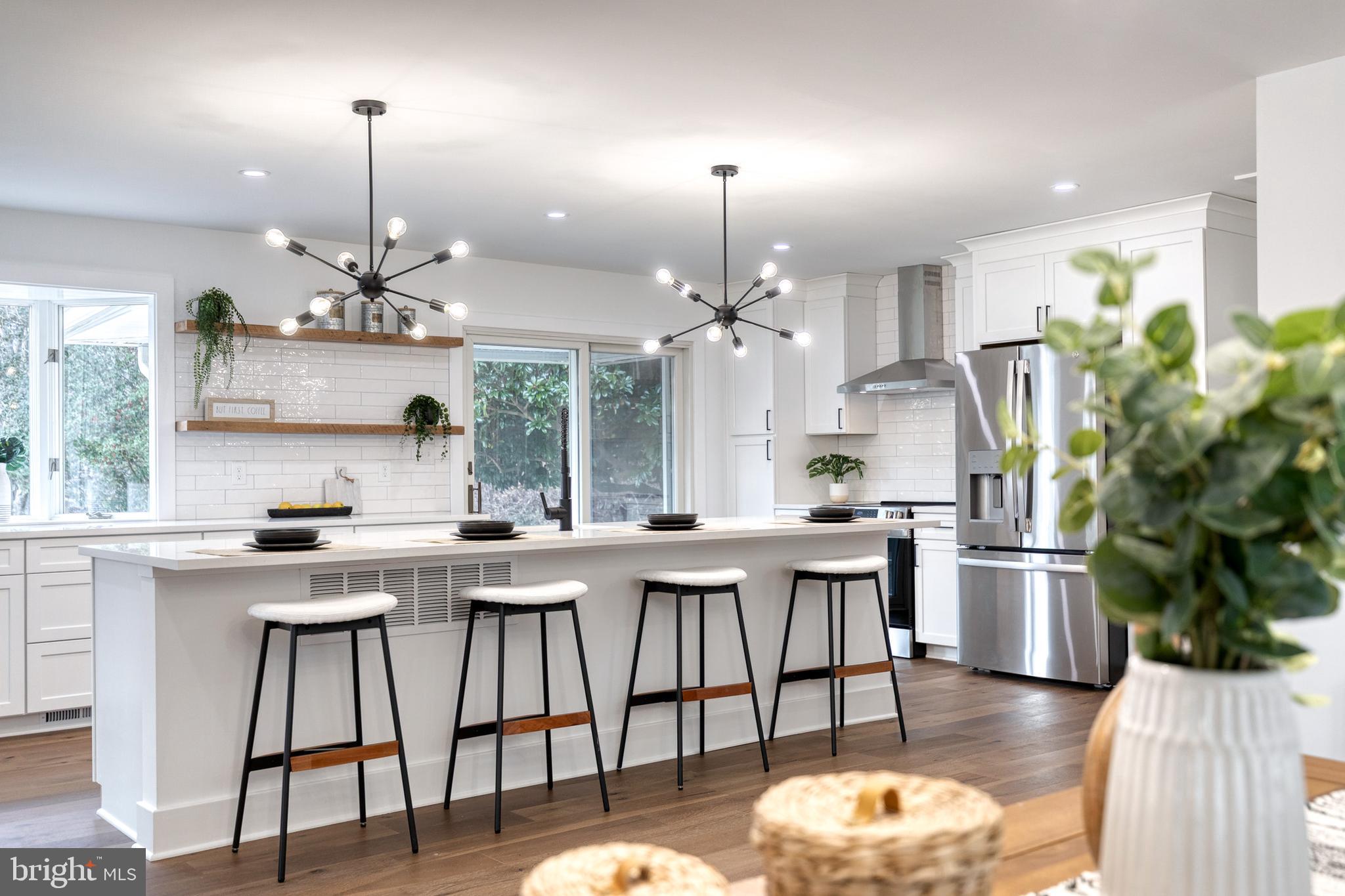 4011 Perry Hall Road Perry Hall, MD 21128 - Photo 23 of 51 a kitchen with stainless steel appliances kitchen island granite countertop a dining table chairs and sink