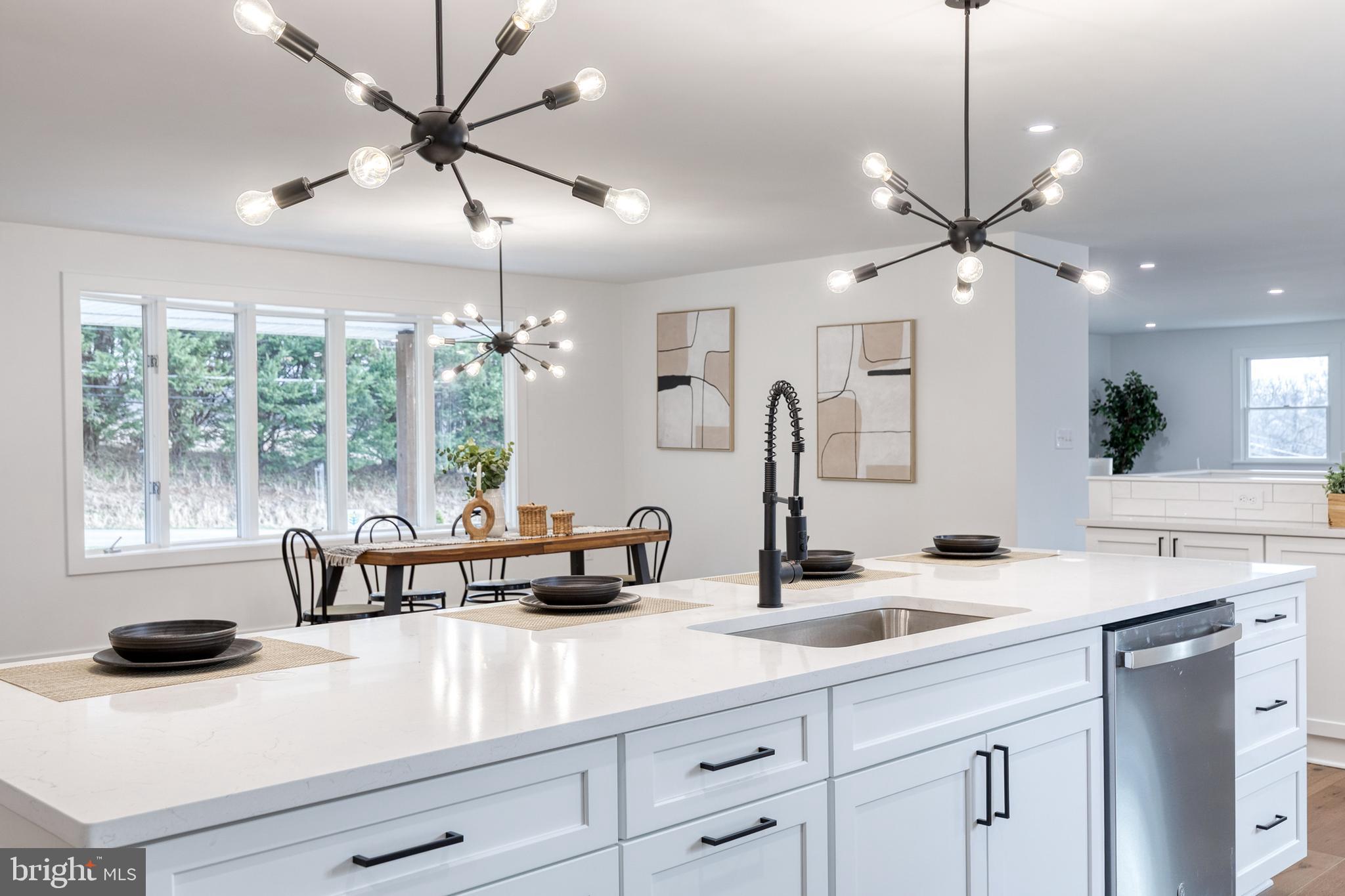 4011 Perry Hall Road Perry Hall, MD 21128 - Photo 31 of 51 a kitchen with a sink a center island a stove and a chandelier
