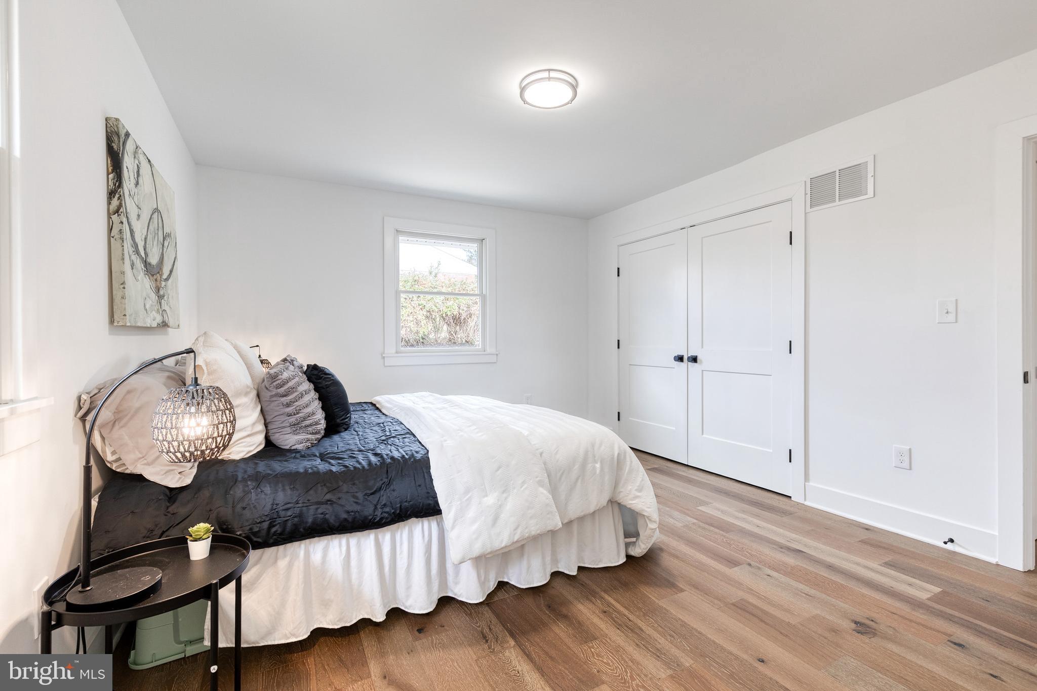 4011 Perry Hall Road Perry Hall, MD 21128 - Photo 34 of 51 a bedroom with a bed and wooden floor