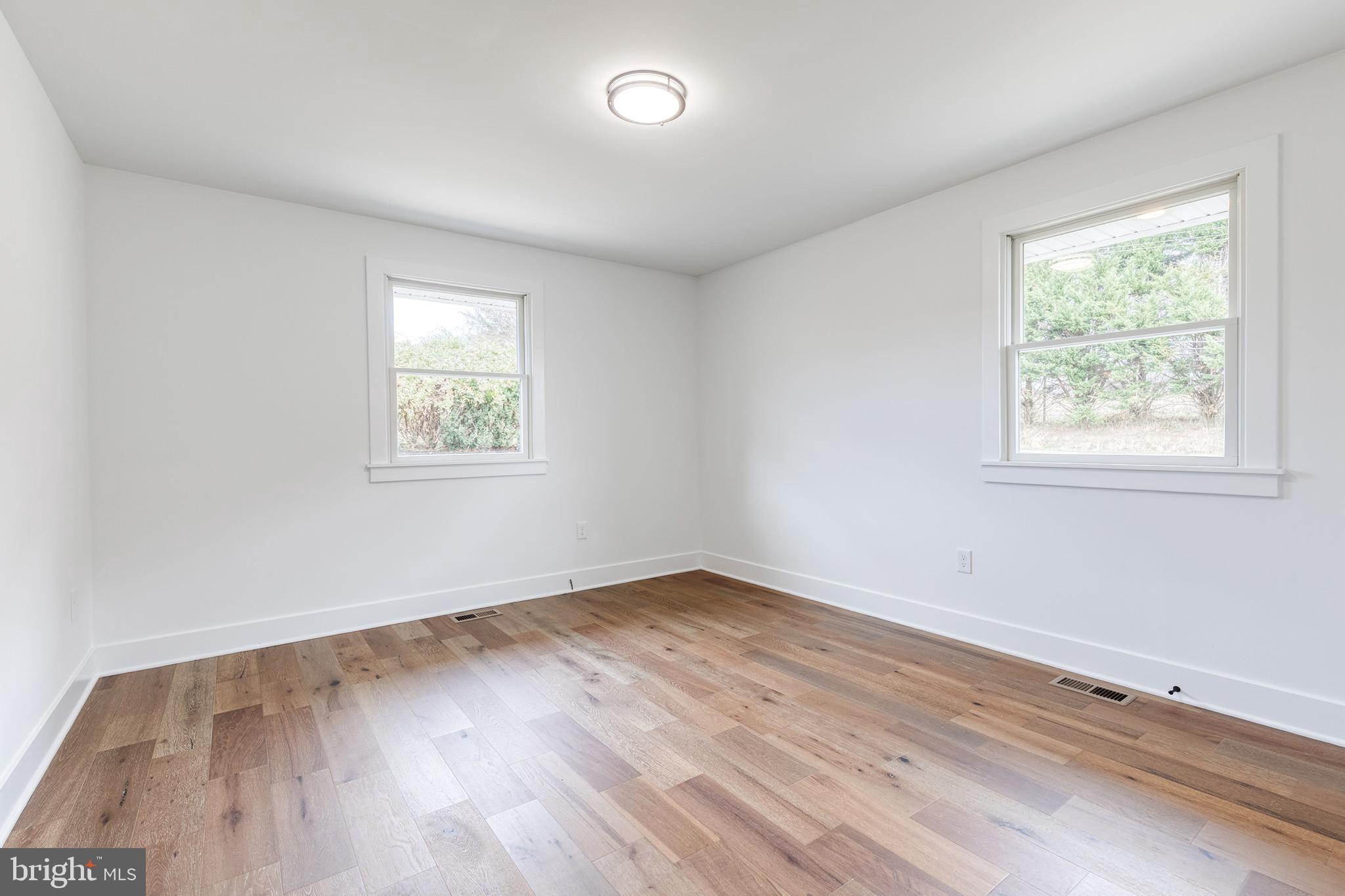 4011 Perry Hall Road Perry Hall, MD 21128 - Photo 36 of 51 an empty room with wooden floor and windows