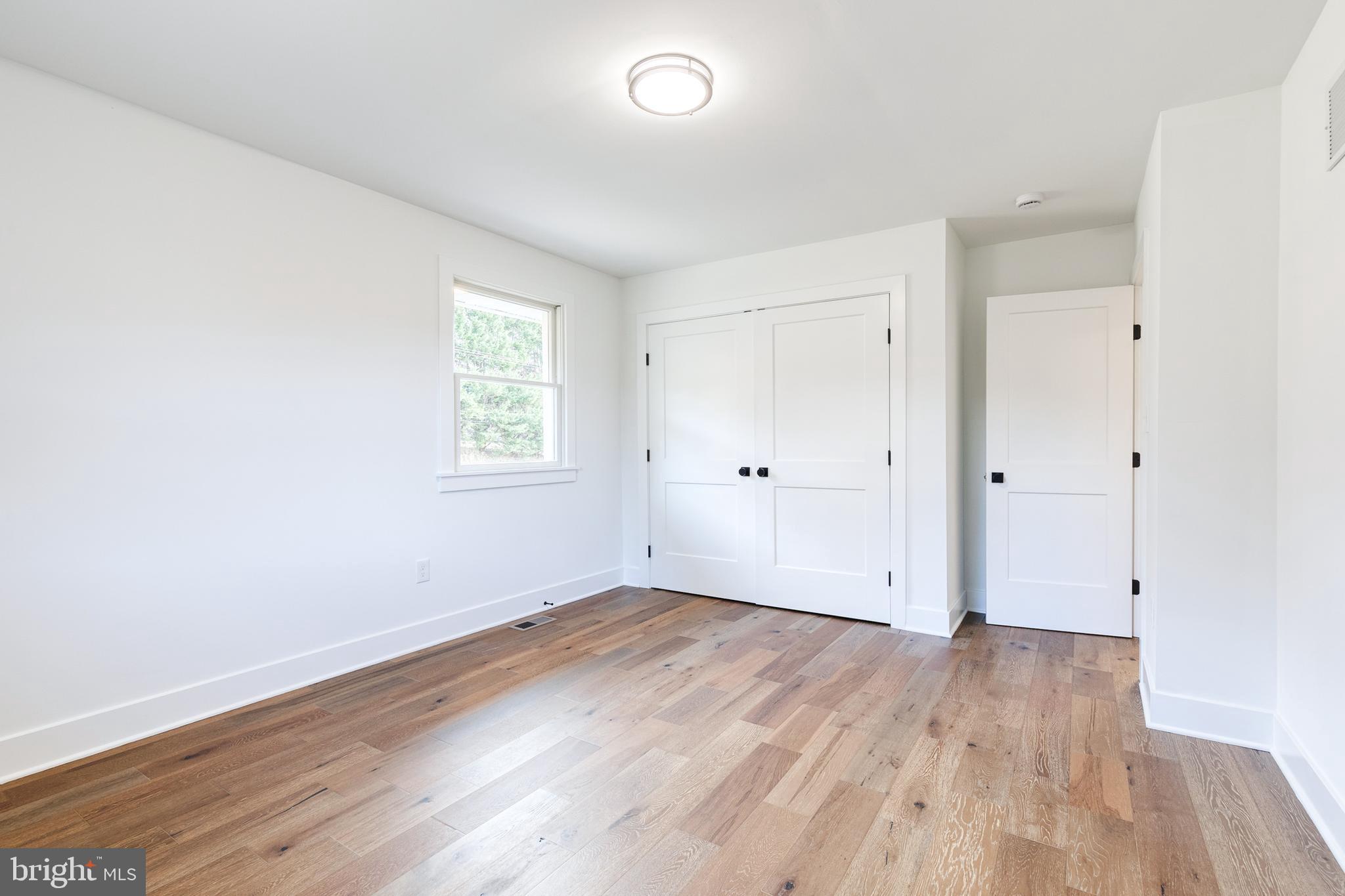 4011 Perry Hall Road Perry Hall, MD 21128 - Photo 37 of 51 an empty room with wooden floor and windows