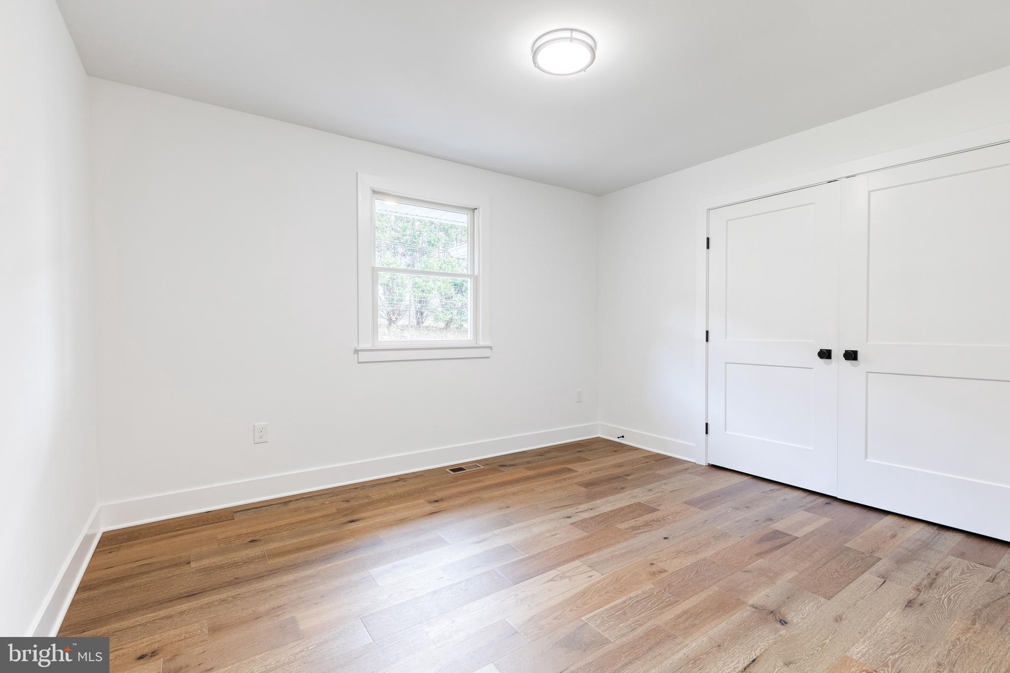 4011 Perry Hall Road Perry Hall, MD 21128 - Photo 38 of 51 an empty room with wooden floor and windows