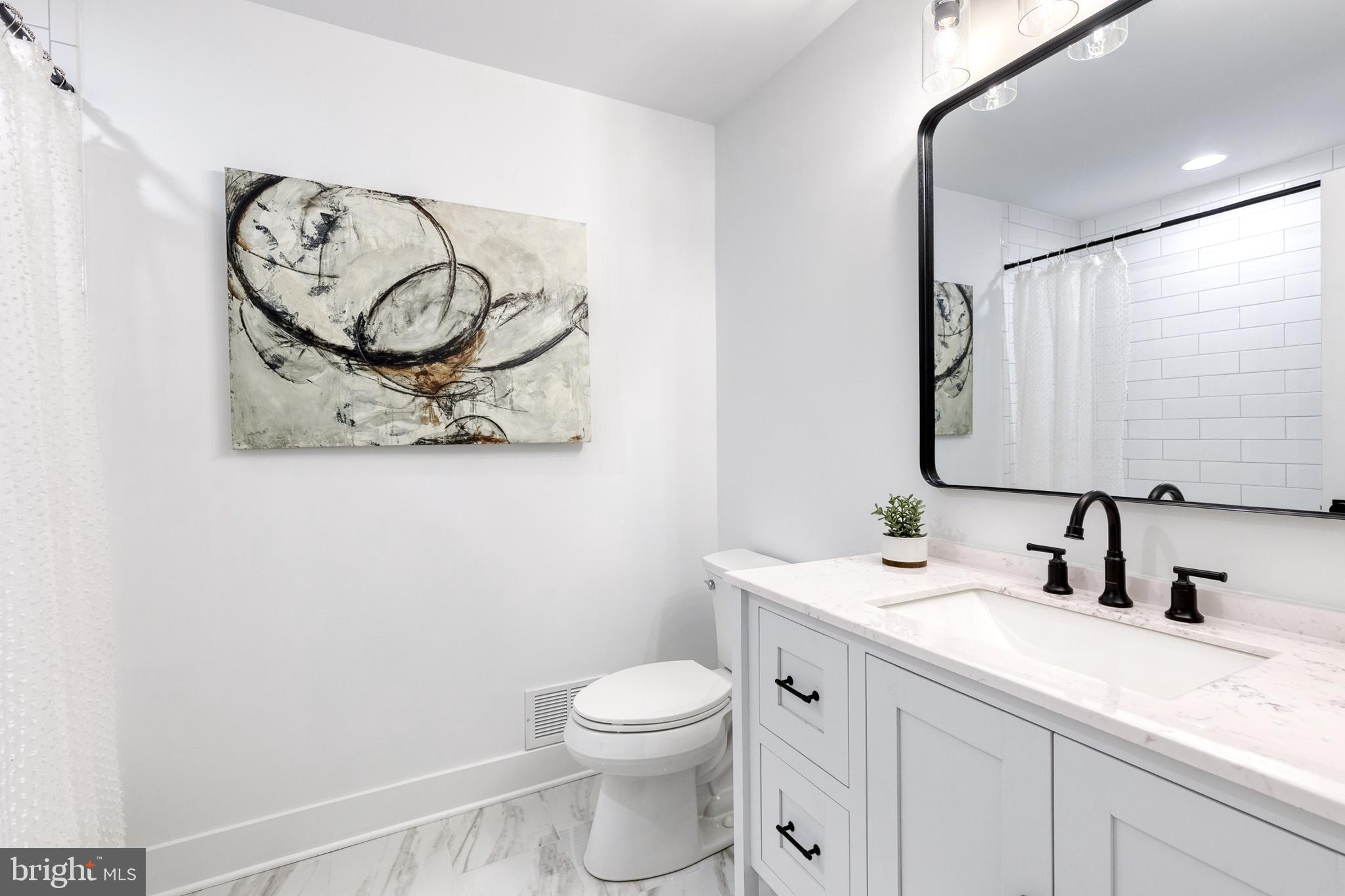 4011 Perry Hall Road Perry Hall, MD 21128 - Photo 39 of 51 a bathroom with a toilet sink vanity and mirror