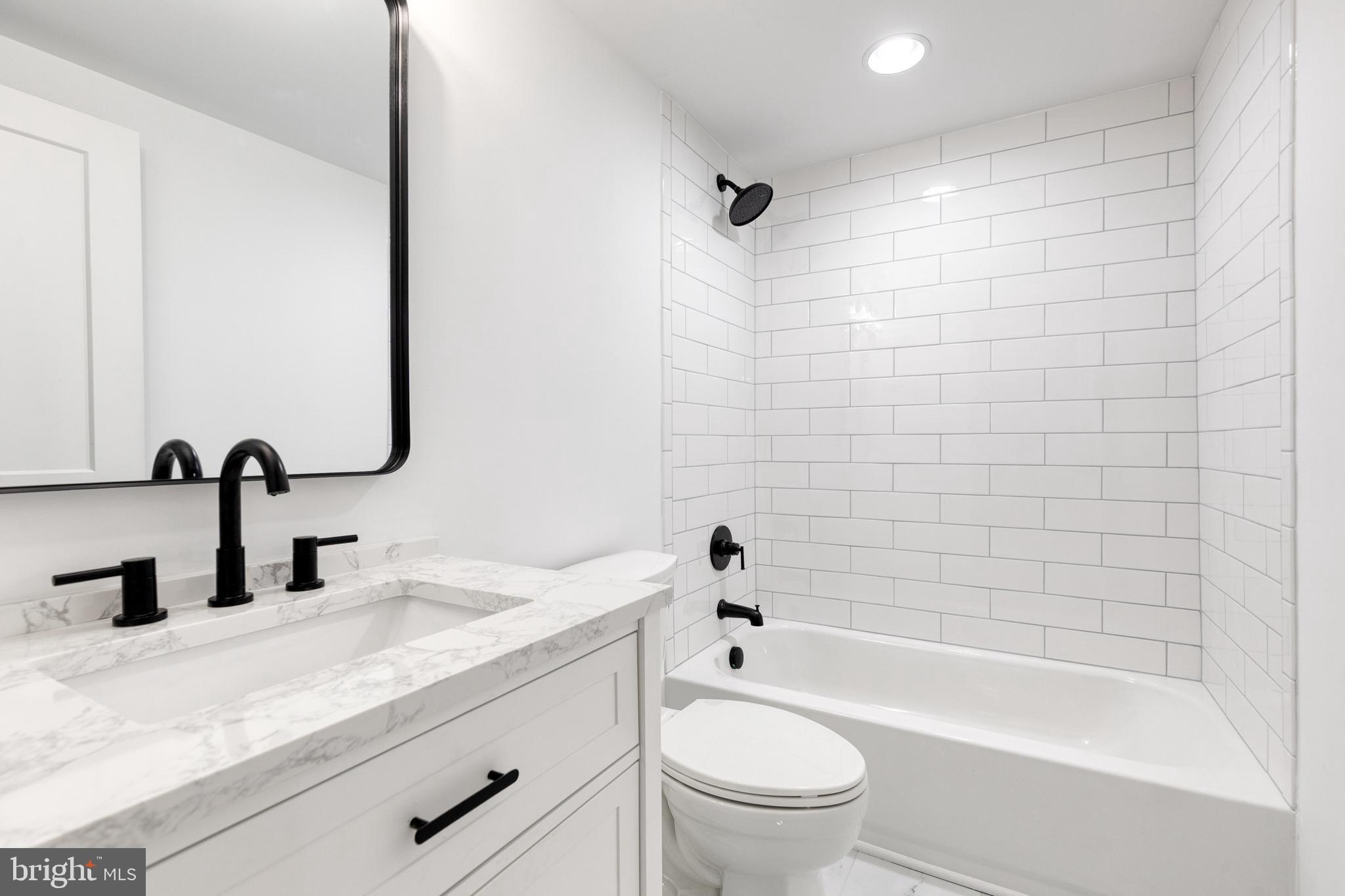 4011 Perry Hall Road Perry Hall, MD 21128 - Photo 45 of 51 a bathroom with a granite countertop bathtub shower sink vanity mirror and toilet