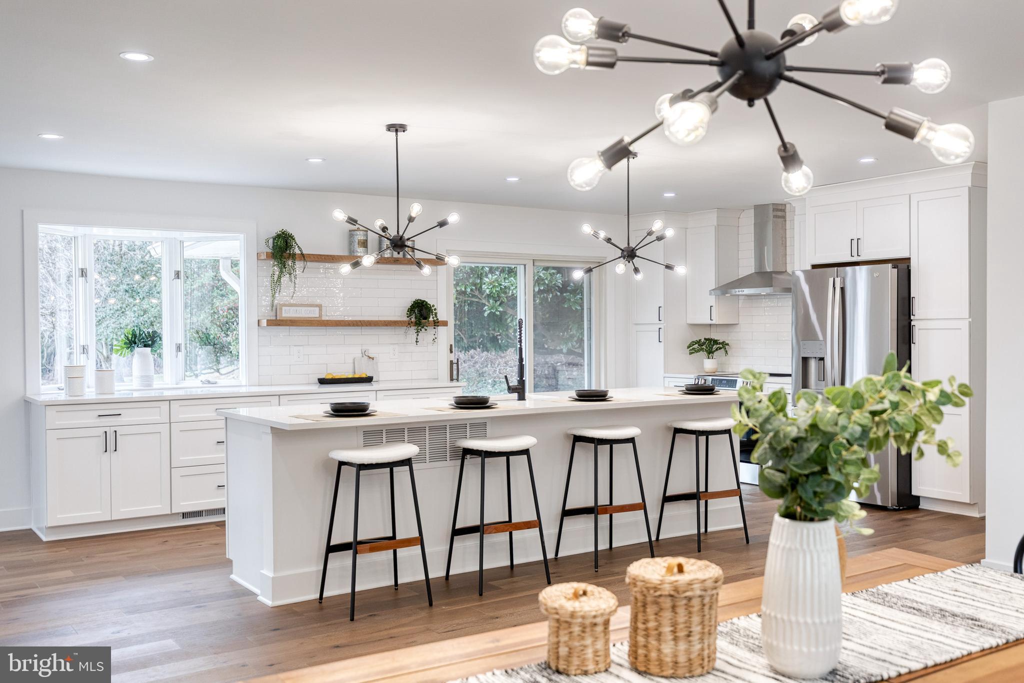 4011 Perry Hall Road Perry Hall, MD 21128 - Photo 5 of 51 a kitchen with stainless steel appliances kitchen island granite countertop a dining table chairs and white cabinets
