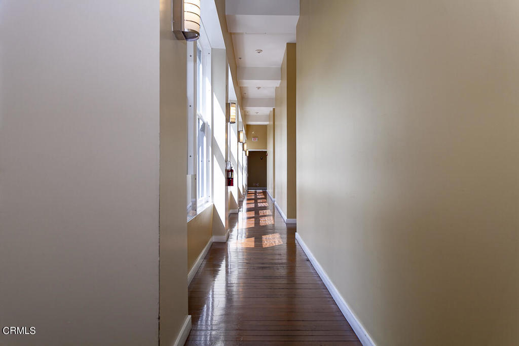 257 South Spring Street, Unit PHE Los Angeles, CA 90012 - Photo 24 of 32 a view of a hallway with wooden floor and staircase