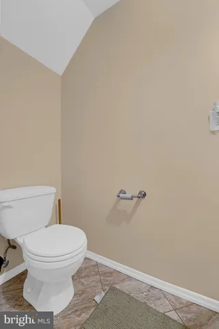 a kitchen with granite countertop a sink stove and cabinets