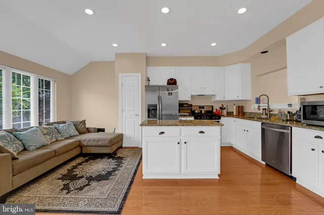 a living room with furniture and kitchen view