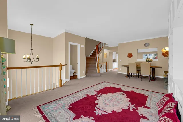 a view of a livingroom with furniture and staircase