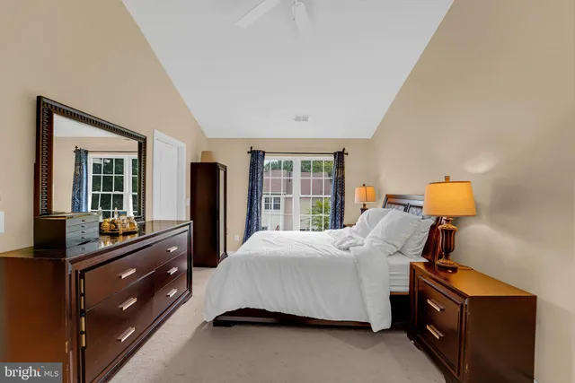 a spacious bathroom with a double vanity sink toilet and a mirror