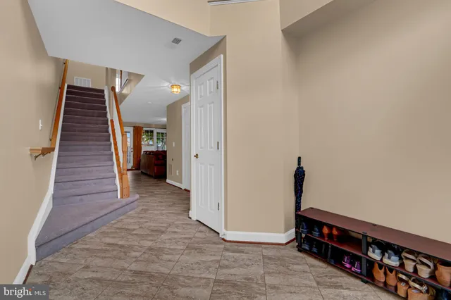 a view of a livingroom with wooden floor and a hallway