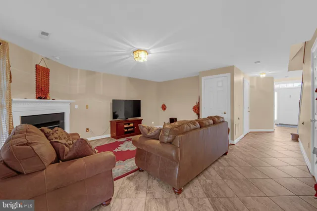 a living room with furniture a rug and a fireplace
