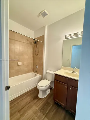 a bathroom with a sink toilet a mirror and shower