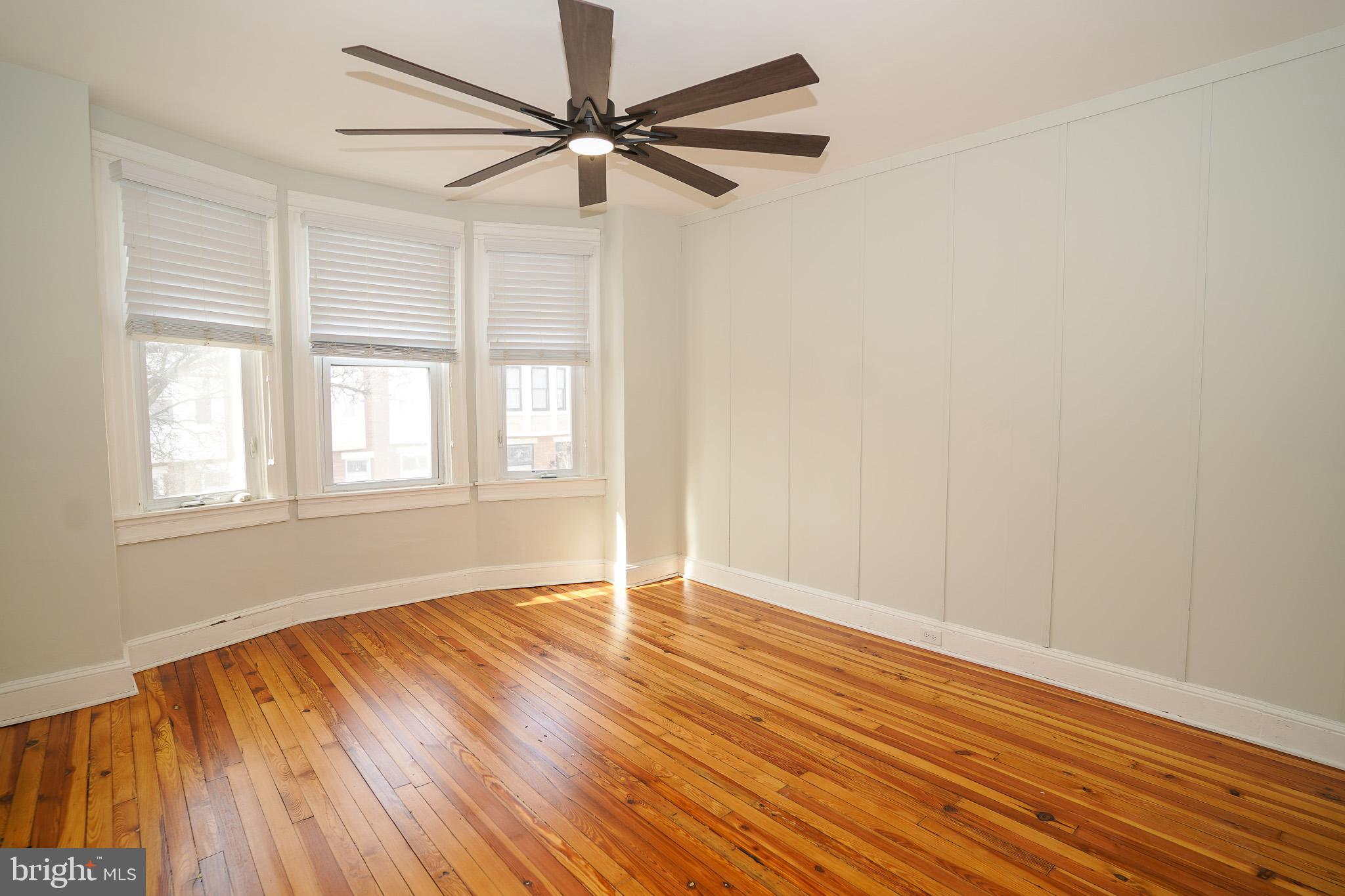713 South Linwood Avenue Baltimore, MD 21224 - Photo 12 of 32 an empty room with wooden floor fan and windows