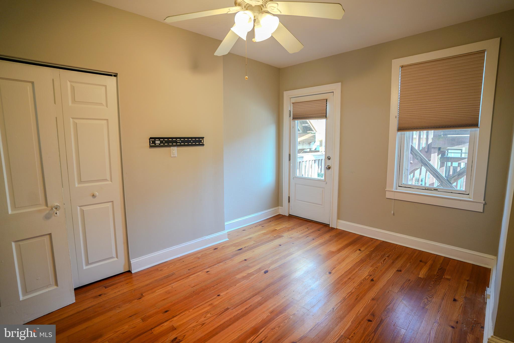 713 South Linwood Avenue Baltimore, MD 21224 - Photo 19 of 32 a view of an empty room with wooden floor and a window