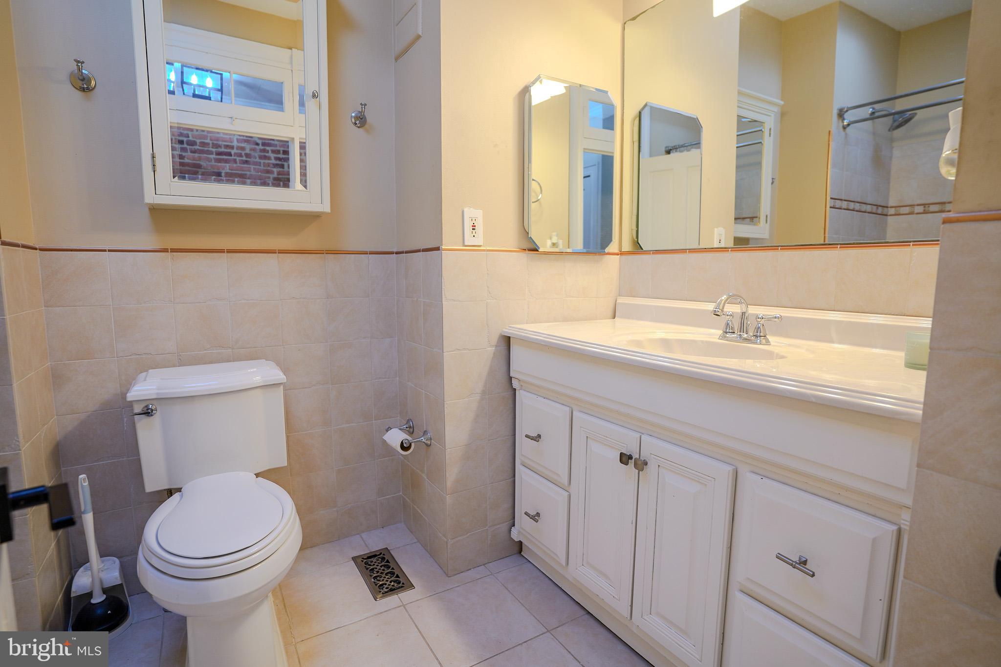 713 South Linwood Avenue Baltimore, MD 21224 - Photo 20 of 32 a bathroom with a toilet sink and mirror