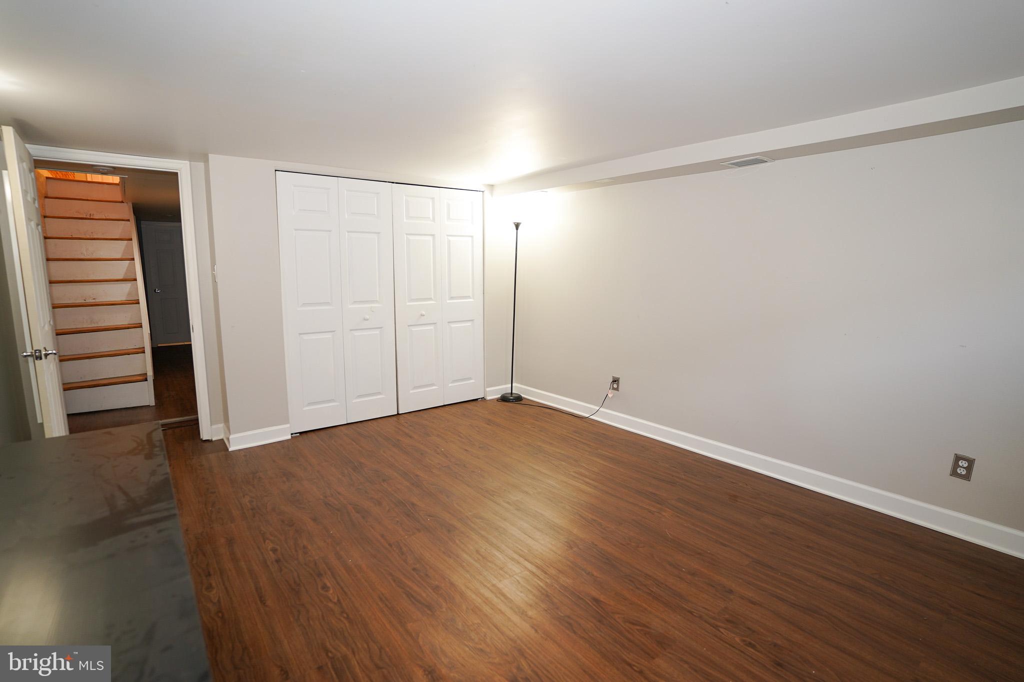713 South Linwood Avenue Baltimore, MD 21224 - Photo 21 of 32 a view of an empty room with wooden floor and closet