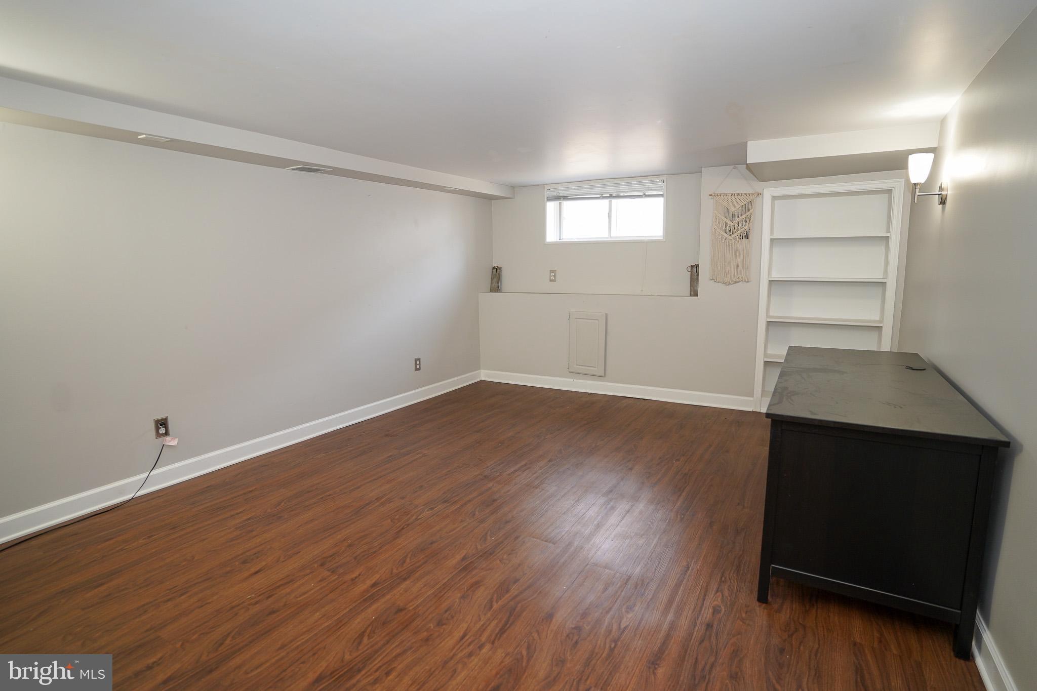 713 South Linwood Avenue Baltimore, MD 21224 - Photo 22 of 32 wooden floor in an empty room with a window
