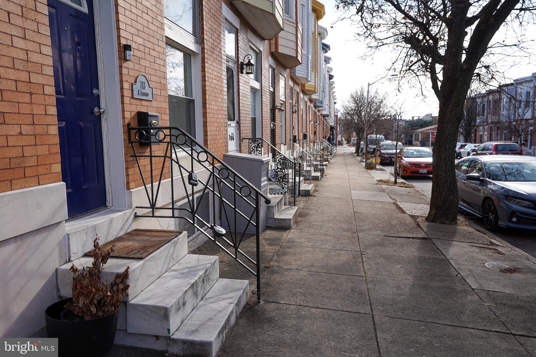 713 South Linwood Avenue Baltimore, MD 21224 - Photo 3 of 32 a view of a patio with couches and table and chairs with wooden fence and plants