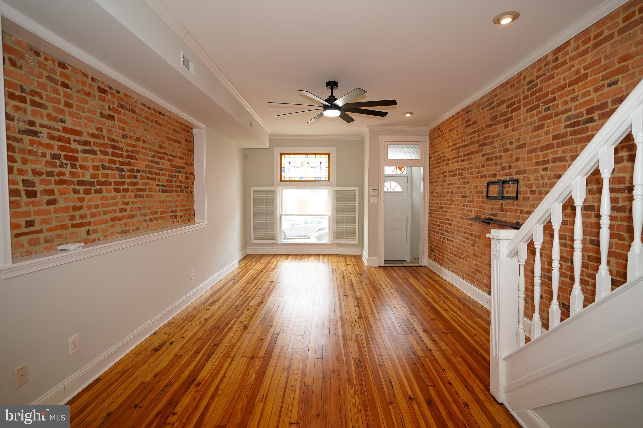 713 South Linwood Avenue Baltimore, MD 21224 - Photo 4 of 32 a view of an empty room with wooden floor and a window