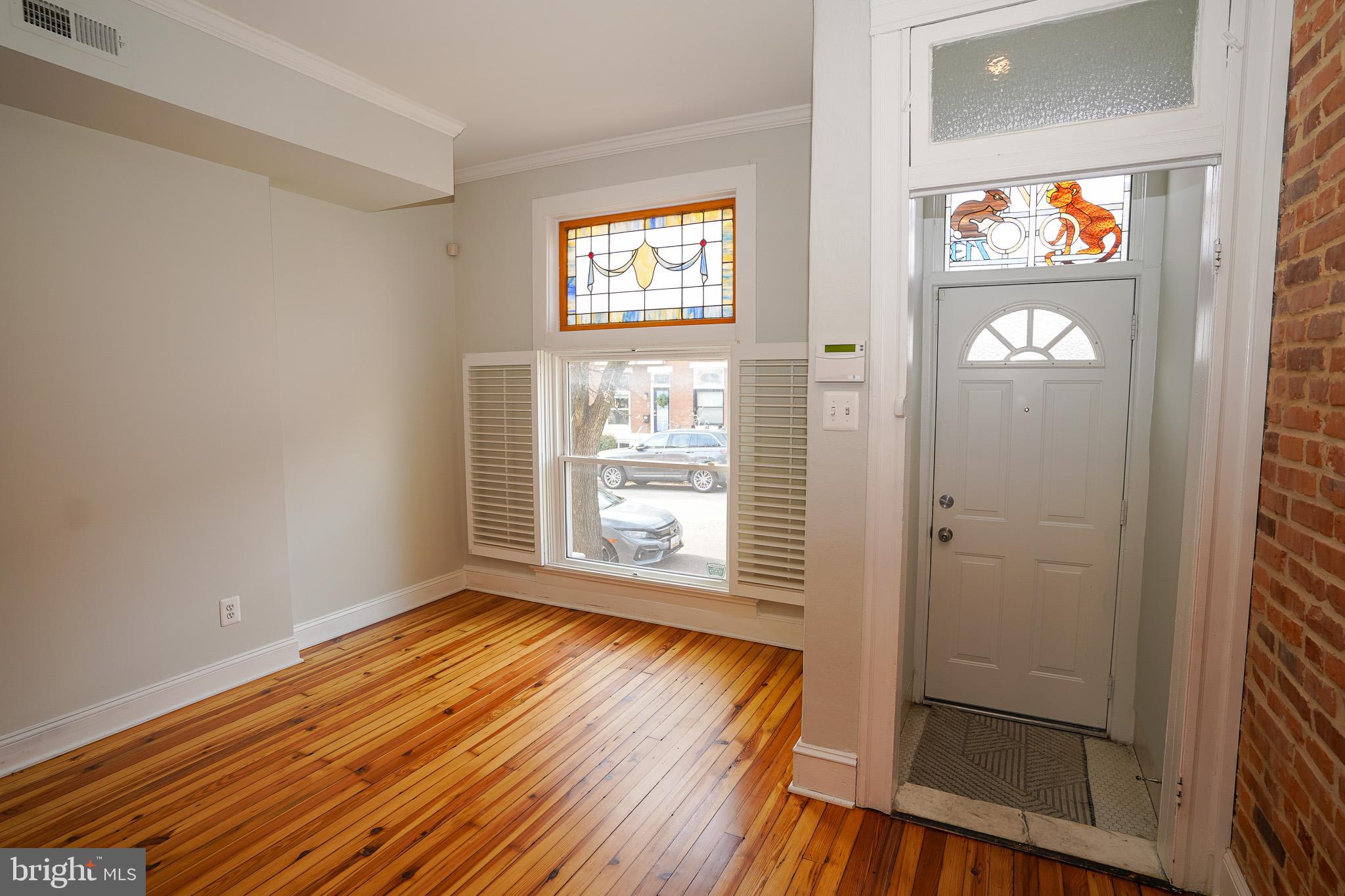 713 South Linwood Avenue Baltimore, MD 21224 - Photo 5 of 32 wooden floor in an empty room with a window