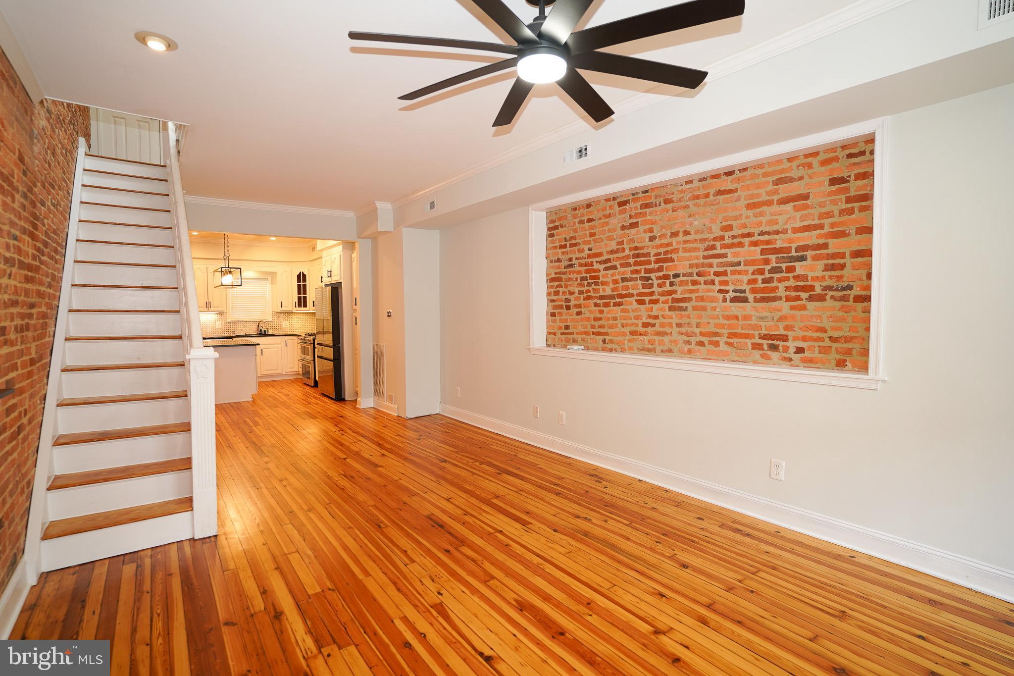 713 South Linwood Avenue Baltimore, MD 21224 - Photo 7 of 32 a view of empty room with wooden floor and window