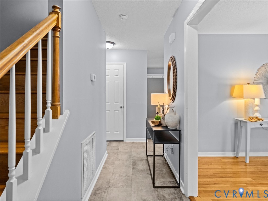 6712 Hedges Road Richmond, VA 23224 - Photo 6 of 34 Entryway featuring a wood staircase with white bal