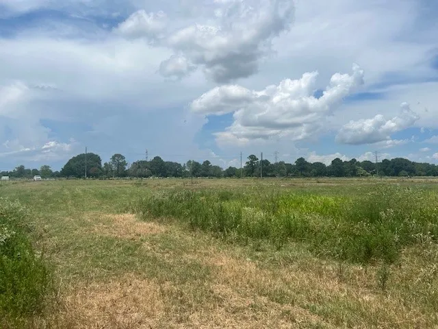 a view of lake with green field