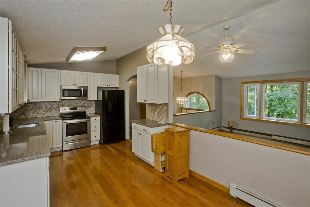 288 Fisk Road Hardwick, MA 01082 - Photo 11 of 42 a kitchen with a chandelier stainless steel appliances and chandelier
