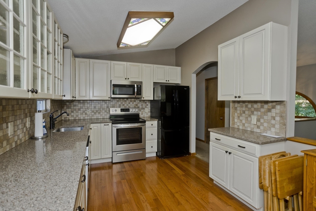 288 Fisk Road Hardwick, MA 01082 - Photo 12 of 42 a kitchen with granite countertop a refrigerator stove and microwave