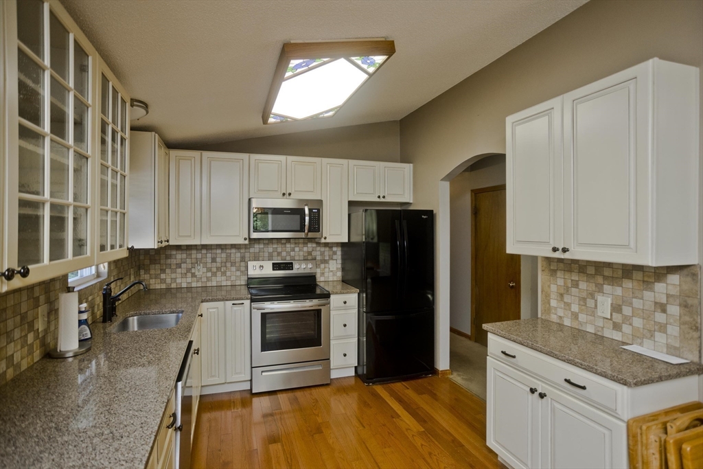 288 Fisk Road Hardwick, MA 01082 - Photo 13 of 42 a kitchen with stainless steel appliances granite countertop a stove a sink and a refrigerator