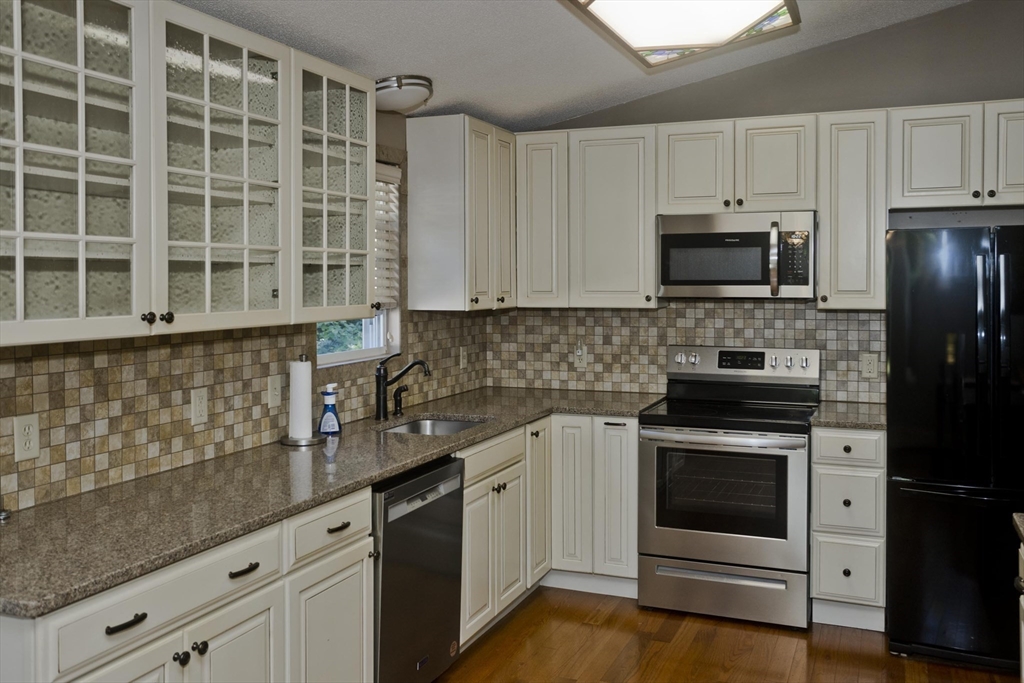 288 Fisk Road Hardwick, MA 01082 - Photo 15 of 42 a kitchen with granite countertop white cabinets and stainless steel appliances