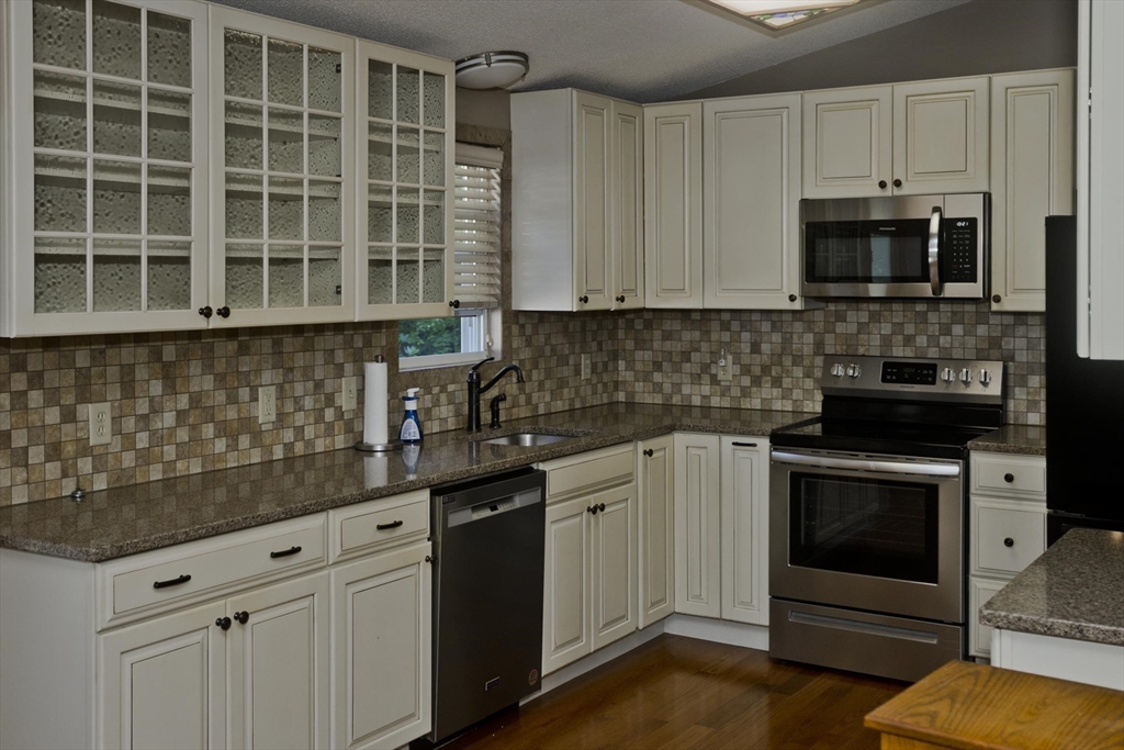 288 Fisk Road Hardwick, MA 01082 - Photo 16 of 42 a kitchen with stainless steel appliances granite countertop a stove a sink and a microwave