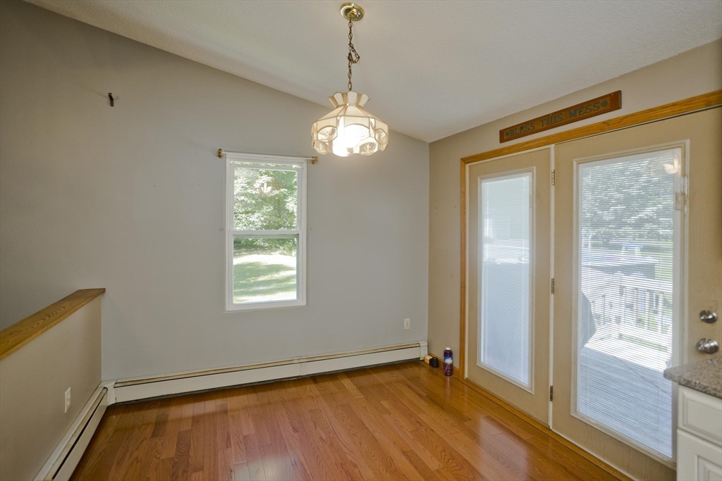 288 Fisk Road Hardwick, MA 01082 - Photo 21 of 42 a view of an empty room with window wooden floor and a window