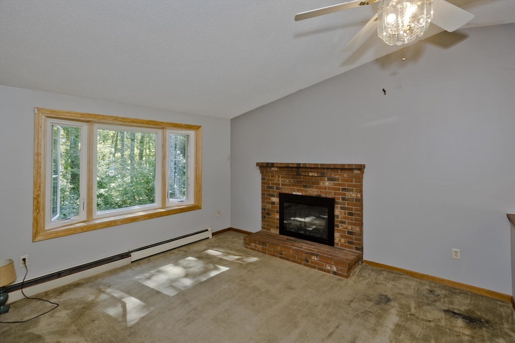 288 Fisk Road Hardwick, MA 01082 - Photo 24 of 42 a view of an empty room with window and fire place