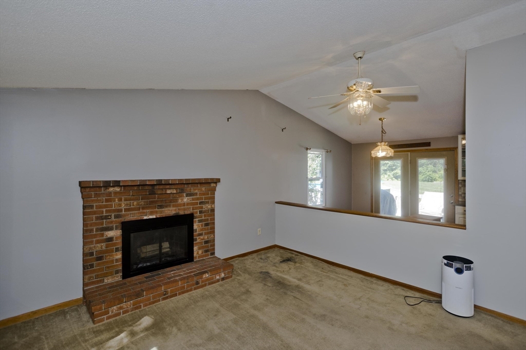 288 Fisk Road Hardwick, MA 01082 - Photo 25 of 42 a view of a livingroom with an empty space and a fireplace
