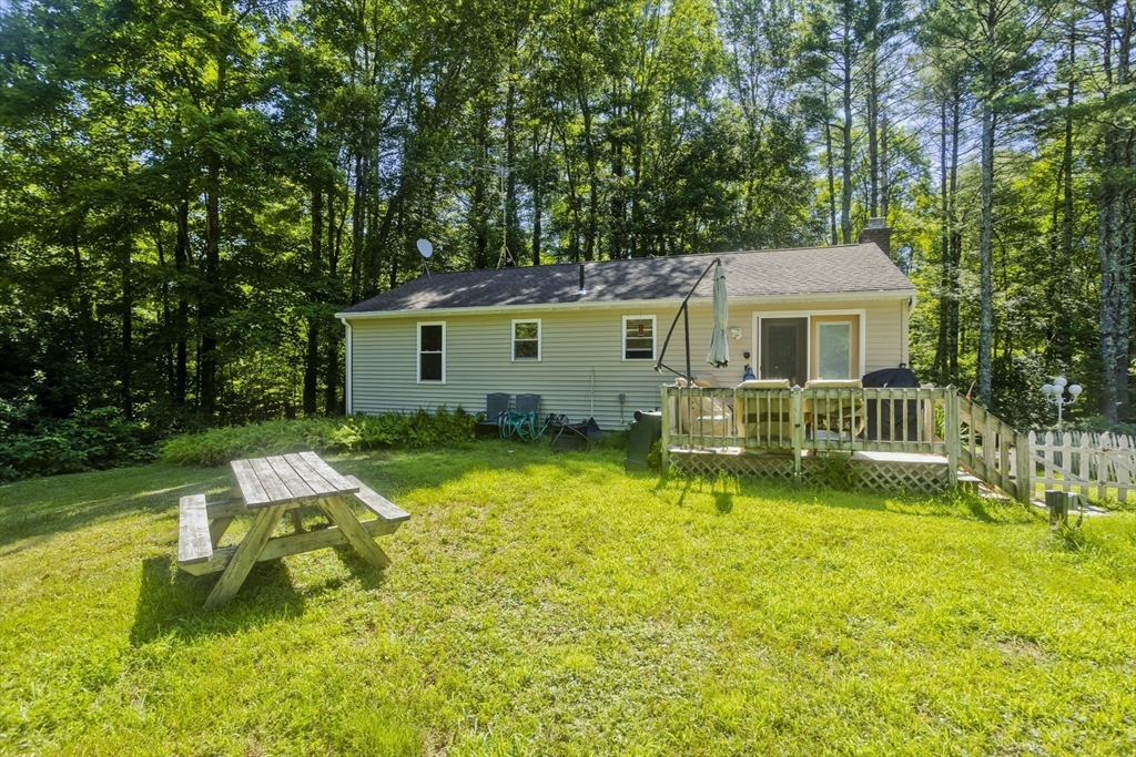 288 Fisk Road Hardwick, MA 01082 - Photo 5 of 42 front view of a house with a yard table and chairs