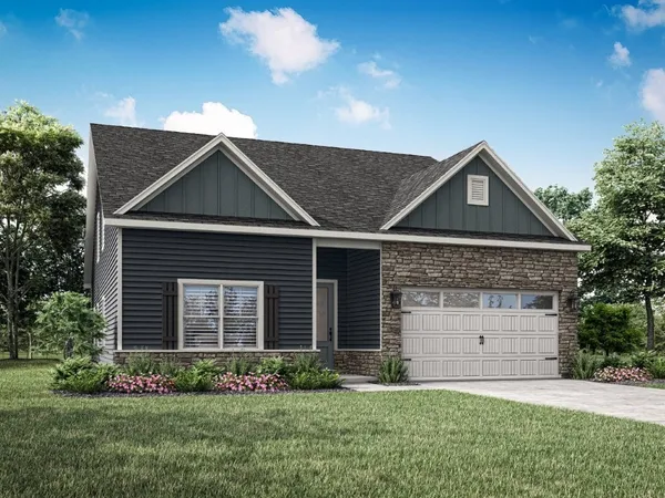 a front view of a house with a garden and plants