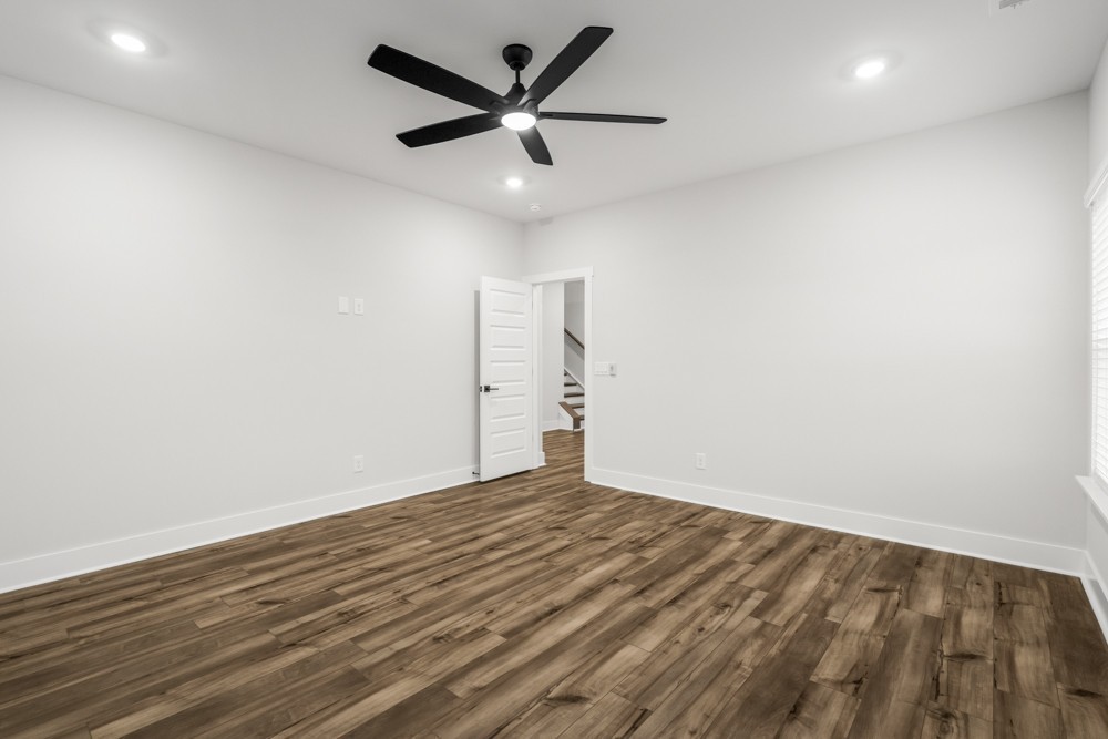 404 Springbrook Boulevard White House, TN 37188 - Photo 14 of 31 an empty room with wooden floor and ceiling fan