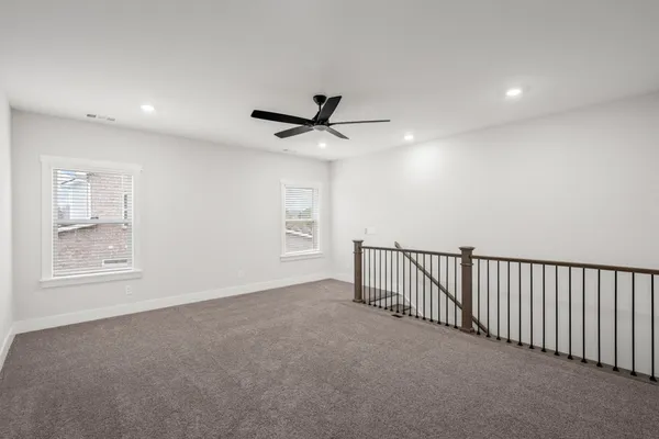 a view of a livingroom with a ceiling fan and window