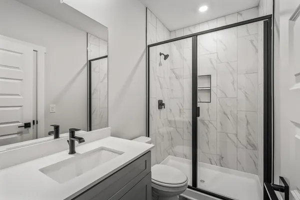 a bathroom with a sink toilet and shower