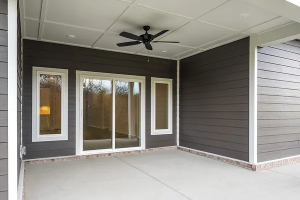 a view of an empty room with a ceiling fan