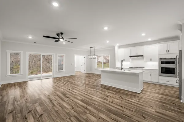 a view of kitchen with cabinets and wooden floor