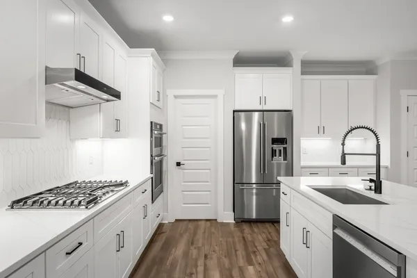 a kitchen with a sink cabinets and stainless steel appliances