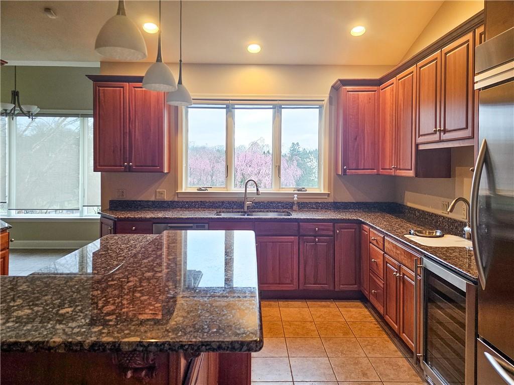 1845 Ferguson Road Allison Park, PA 15101 - Photo 24 of 50 a kitchen with large windows and wooden cabinets